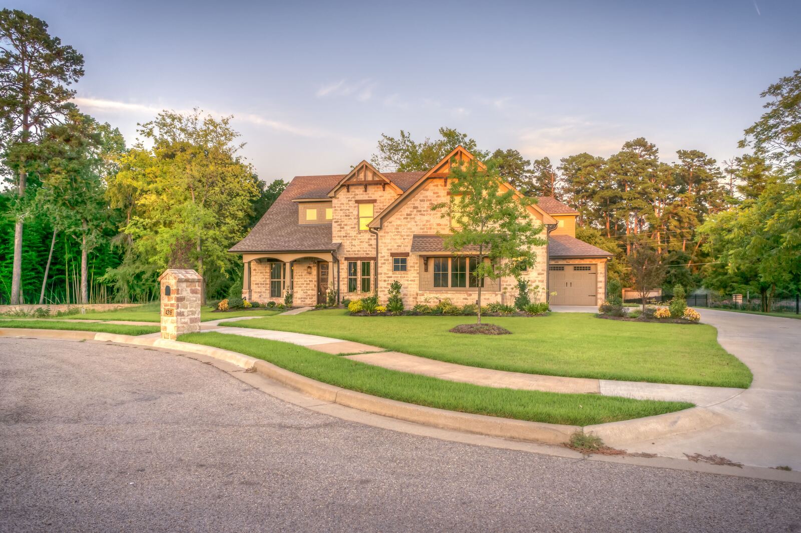 A family home with a landscaped yard and mature trees on a quiet curving street