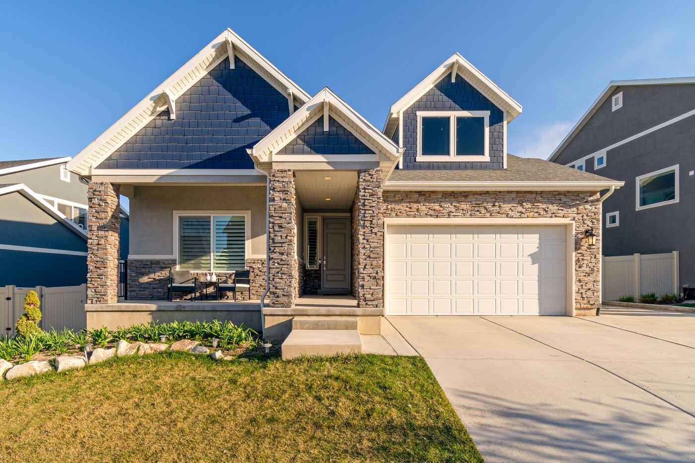 A new two-story home with a stone front, covered porch and two-car garage